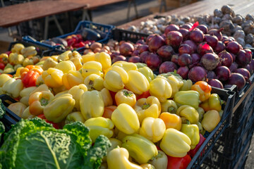 Local farmer’s market with October seasonal fruits and vegetables in Croatia. Peppers, red onions