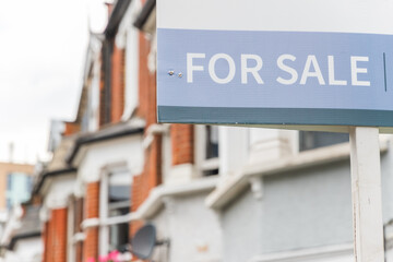 For Sale signs displayed outside terraced houses in London