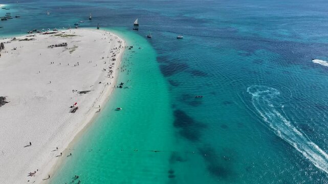 Aerial video footage of area around the historic Stone Town, the oldest part of Zanzibar Town on Unjuja island, Tanzania, starting at Shangani Beach, flying along historic buildings and landmarks 