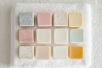 Fototapeta premium Variety of pastel-colored soap bars arranged neatly
