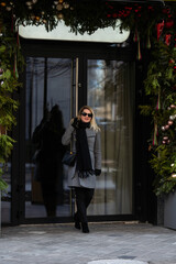 Christmas walk in city adult girl walks in the city on a festive , the lights of city are new year