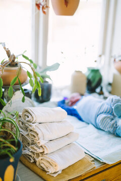 Stack of reusable diapers on table at home