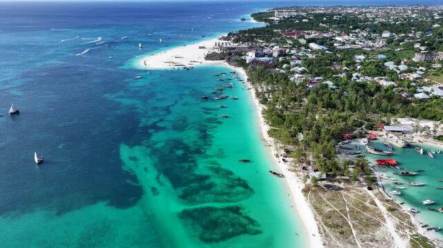 forward flight aerial landscape video view of Kendwa Beach area, in the north part of Unguja Island, Zanzibar, with white sand strand and village of Kendwa in the background - 4k aerial video footage
