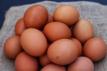 Chicken eggs are made in a pile with a close up view.