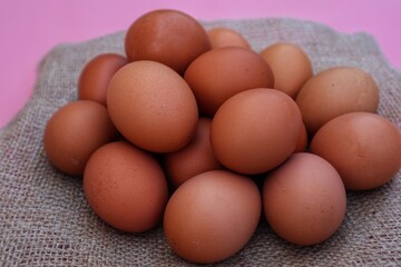 Chicken eggs are made in a pile with a close up view.