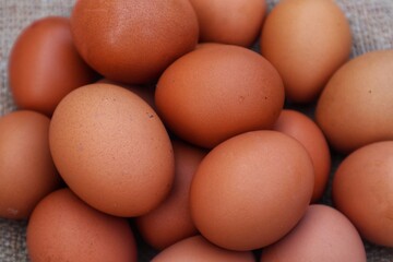 Chicken eggs are made in a pile with a close up view.
