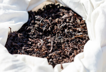 A bag of tea leaves is sitting in a white cloth
