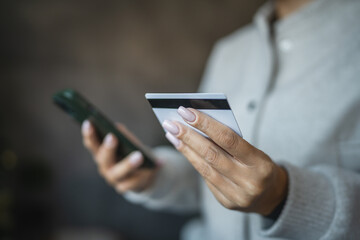 Adult woman use smart phone for online shopping transaction safely