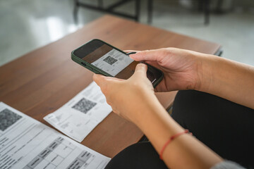 woman do contactleess payment on cellphone and pay bills