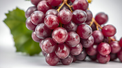 Fresh red grapes on a blurred background with green leaves for healthy lifestyle concept
