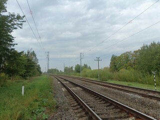 Two way railroad tracks in countryside. Two railway tracks. Cloudy day. Countryside. Fields and...