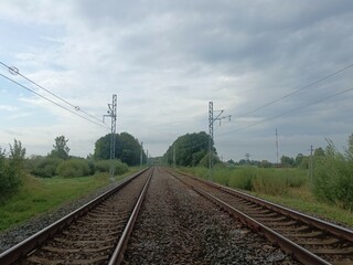 Two way railroad tracks in countryside. Two railway tracks. Cloudy day. Countryside. Fields and...
