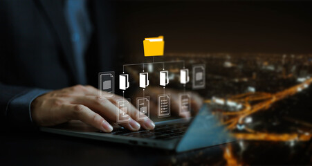 Businessman working with laptop computer with document management icons on virtual screen