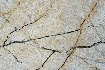 Cracked light beige stone surface