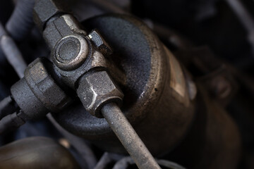 Leaked air condition system of the cars. AC refrigerant leaking shown on sight glass and receiver drier. Background for car maintenance or automobiles. Selective focus and copy space.