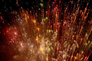 Looking up at pretty fireworks illuminating the night sky © lemanieh