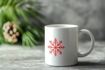 A plain white mug with a single red snowflake design on a neutral grey surface. 