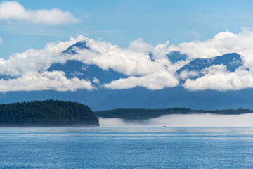 Whale watching boat silhouette in mist and fog, Telegraph Cove, Vancouver Island, British Columbia, Canada.