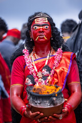 Kulasai Dasara, Portrait of indian woman with painted face and dressed as hindu god kali to perform...