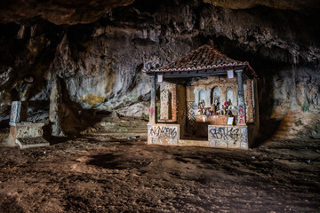 Dark interior of Lapa de Santa Margarida cave with small chapel of spontaneous worship, Arrábida - Setúbal PORTUGAL