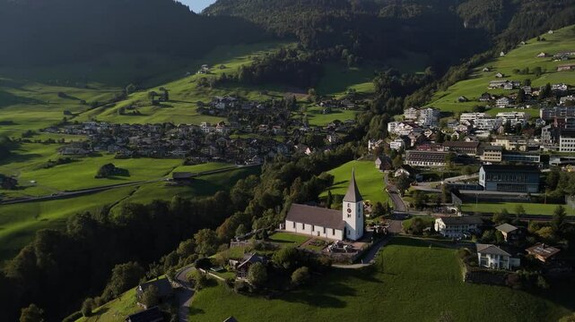 Swiss Switzerland alpine village surrounded by beautiful nature, aerial