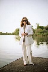 Full length of a mid aged woman standing by the lakeside