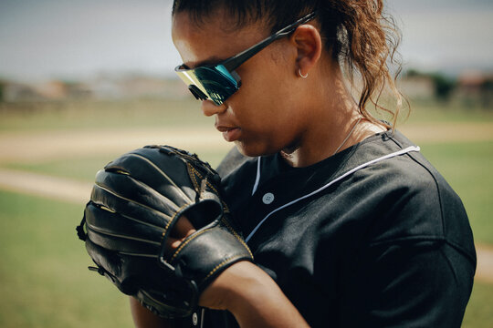 Tenacious professional baseball player in sunglasses holding a glove