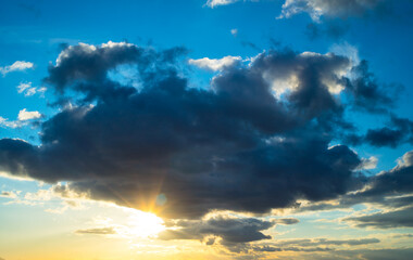 Dark clouds and sun at sunset