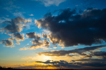 Dark clouds and sun at sunset