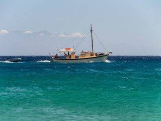 Obraz premium Fishing boat in the Mediterranean Sea on the island of Mykonos in Greece