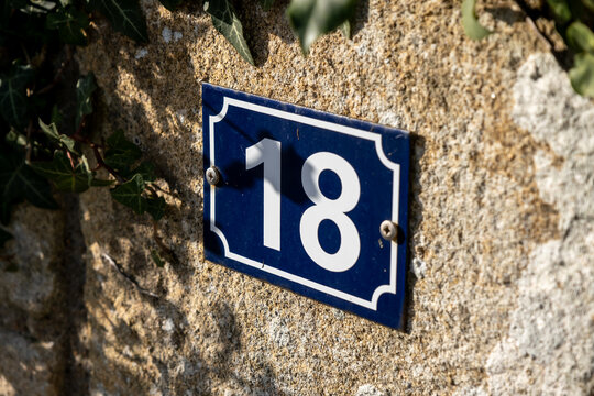 number eighteen on a stone wall