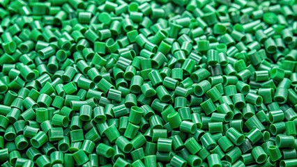 Fototapeta premium Green plastic granules of Polyethylene terephthalate PET biopolymer material for recycling point of view.