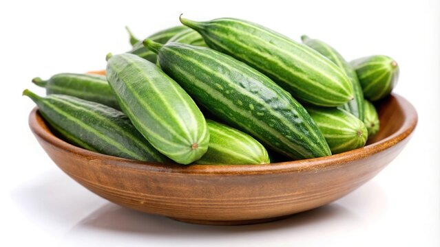 Green pointed gourd or parwal in a bowl isolated on white background with tilted angle