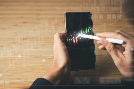 Business using mobile phont with financial graph for business investment growth. Financial, data analysis, goal,success and money concept.