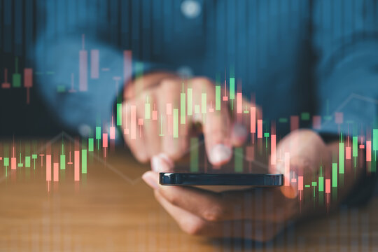 Businessman using mobile phont with financial graph for business investment growth and money concept.