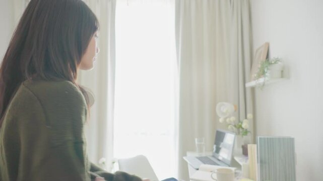 Asian young girl entering her room to study table in bedroom at home. 