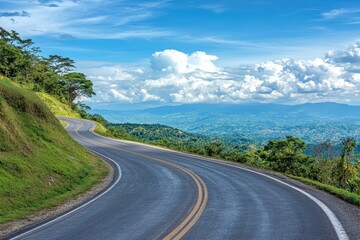 A winding road leads through a lush green valley.