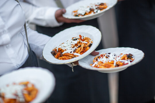 Waiters Serving Freshly Plated Pasta with Cheese Topping - Powered by Adobe