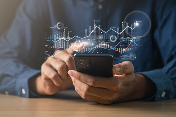 Businessman using mobile phone with exponential arrow and financial graph for business investment growth. Financial, data analysis, goal,success and money concept.