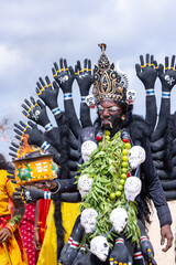 Kulasai Dasara, Portrait of indian woman with painted face and dressed as hindu god kali to perform...