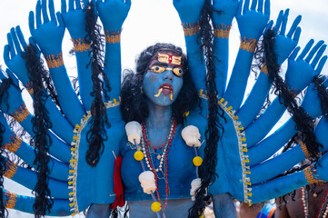Kulasai Dasara, Portrait of indian woman with painted face and dressed as hindu god kali to perform...