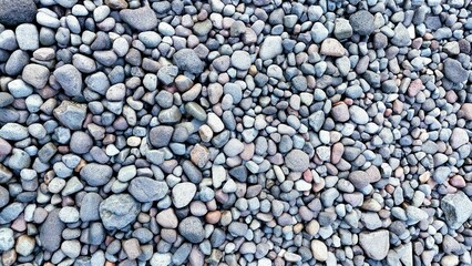 Small smooth edge pebble stones texture background