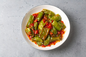 Fried green peppers with tomato sauce - Turkish name; domates soslu biber kizartmasi