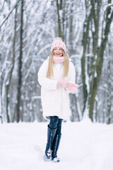 Girl laughs, have fun in the winter park. Beautiful young woman Enjoying nature, winter