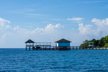 Beautiful tropical paradise of Pandanan Island with Arcadia Beach Resort Jetty or Pier, Semporna, Sabah, Malaysia (Borneo).