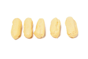 Neatly stacked mini cream puffs (sus kering) in a thumb-sized, golden-yellow shape. Photographed on a white background. Perfect as a light snack.