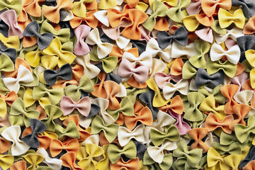 Top view of colorful farfalle pasta with natural dyes