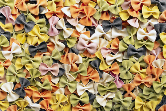 Top view of colorful farfalle pasta with natural dyes