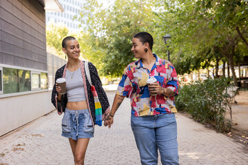 Hispanic lesbian couple enjoying a walk in the park
