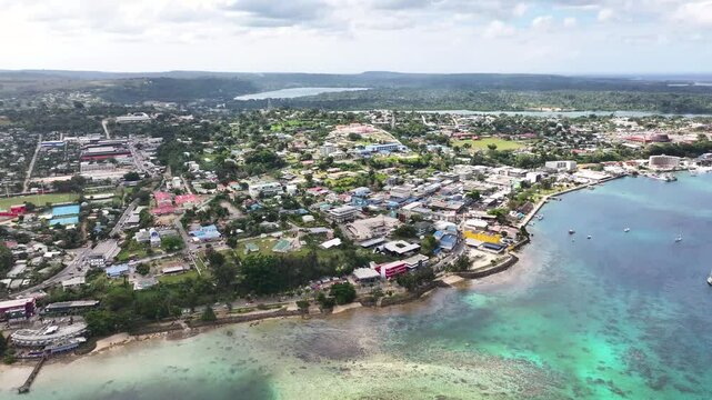 Port Vila, Efate, Vanuatu - A Scenic View of a Captivating Harbor City Featuring Turquoise Waters and Boats Anchored Peacefully - Aerial Drone Shot